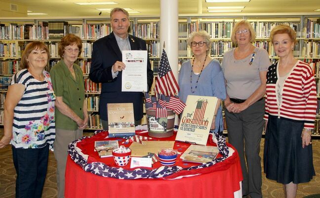 DAUGHTERS OF THE AMERICAN REVOLUTION encourages Americans to celebrate the United States Constitution and recognize its importance and how it sets the framework for our government. Here, representatives of the Sarah Barton Murphy Chapter of the D.A.R. joined Village of Caledonia Mayor John Robinson III as he presented a Proclamation from the Village for Constitution Week, September 17th thru 23rd at the Washington County Library. The Ladies expressed their appreciation for the support and want to promote the importance of our country’s Constitution. The Constitution established America’s way of life and the liberties that citizens enjoy. The Constitution was signed by delegates of the Constitutional Convention on September 17th, 1787. Representing the D.A.R. from left are Registrar Joan Dostal, Thelma Robinson, Mayor Robinson, Historian Sue Hensley, Regent Karen Kleinburg, Chaplain Pat Colyer (Past Regent). The D.A.R. and the Washingtron County Library have a U.S. Constitution display set up beginning this week. Celebrate America!