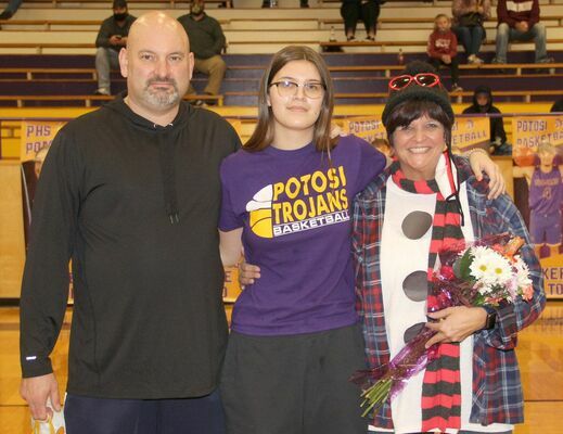 SENIOR LADY HONORED – Rain Hongsermeier-Baxter, #45 for the Lady Trojans was recognized with her mom, Shari Hongsemeier-Baxter and her dad, Kevin Baxter on Monday, Dec. 14th at the P.H.S. gym.