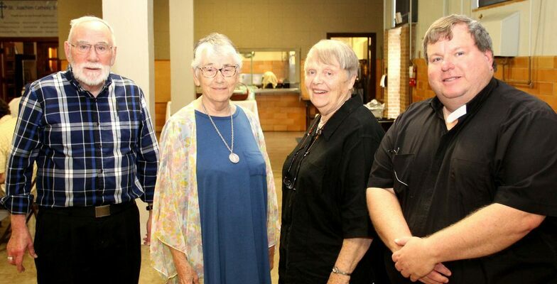 Here, Father Mark Boyer, Miss Natalie Villmer, Miss Neva Calvert and Father Tony Dattilo take a moment for a photo during a celebration brunch held in the St. Joachim Catholic School cafeteria following the Mass service in Old Mines.
