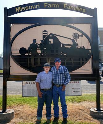 WASHINGTON COUNTY FARM FAMILY AT STATE FAIR – Gunnar and Brian Merkel stand in front of the new sign at the Missouri State Fair in Sedalia during this year’s Bicentennial Fair Celebration in August. The Merkels said they had a good time and learned a lot. (Sub. Photo)