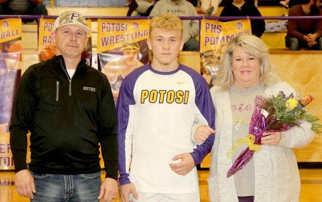 SENIOR BASKETBALL PLAYER Landon Bone was joined on the court by his mom and dad, Ryan and Stephanie Bone for Senior Night. Landon plans on attending M.A.C. and playing baseball.