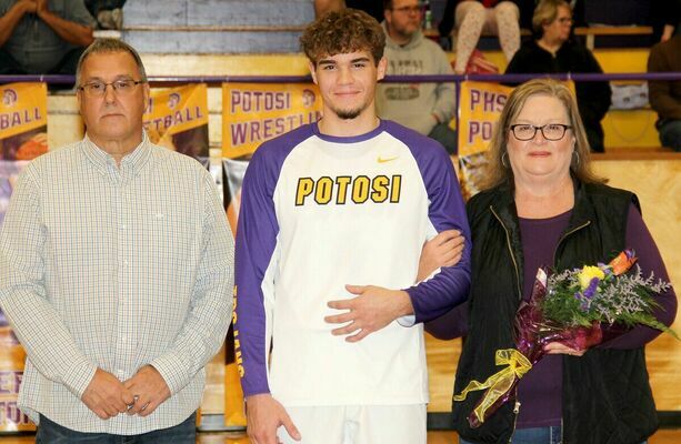 RYKER WALTON, #4 for the Trojan Basketball Team was recognized with his parents, Tim and Kim Walton. Ryker plays basketball and baseball for Potosi and will continue his baseball career at M.A.C.